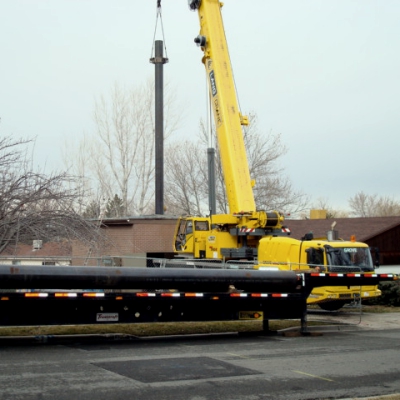 Crane installing well casing